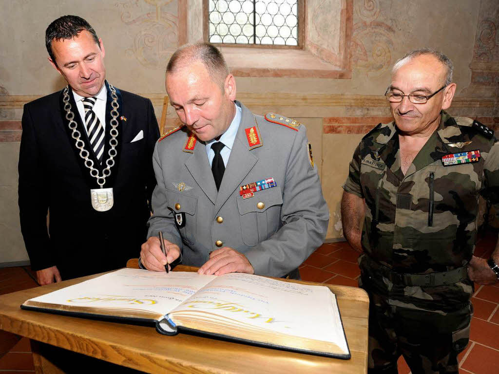 Der Inspekteur des Heeres,  Hans-Otto Budde (Mitte) und sein franzsischer Kollege Elrick Irastorza  tragen sich ins goldene Buch  ein.