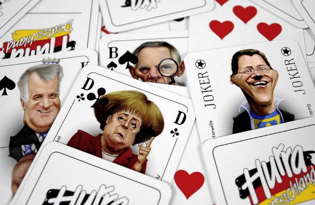 Spielkarten mit Politiker-Karikaturen ...  ber Details des Koalitionsvertrags.  | Foto: dpa