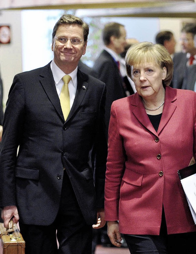 Neues Team: Guido Westerwelle und Angela Merkel in Brssel   | Foto: DPA