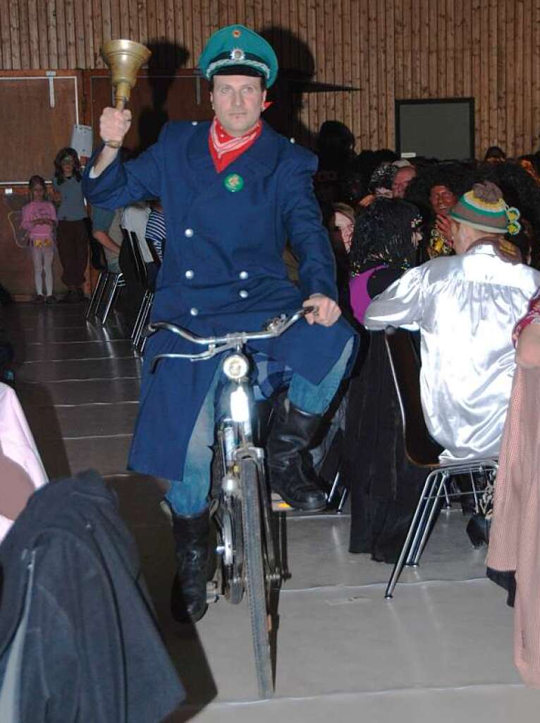 Dorfbott Mike Gerber rollt auf dem Fahrrad in die Halle.