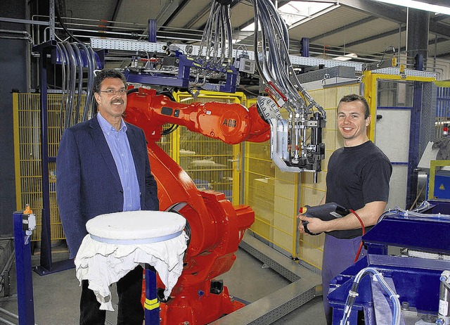 Peter Ebner (links) und Mitarbeiter Artem Weber (rechts) vor dem neuen Roboter   | Foto: Lins