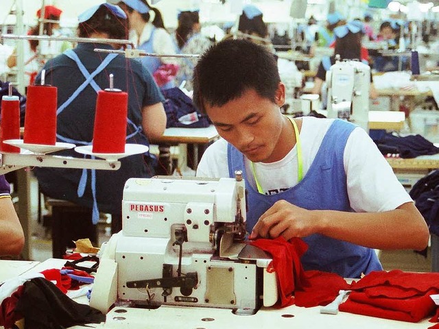 Ein Arbeiter produziert in Guangzhou Sportbekleidung fr Adidas.   | Foto: Koch/Adidas