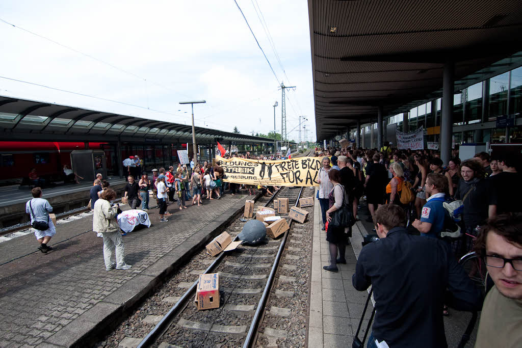 Aktivisten besetzen Gleis in Freiburger Hauptbahnhof.