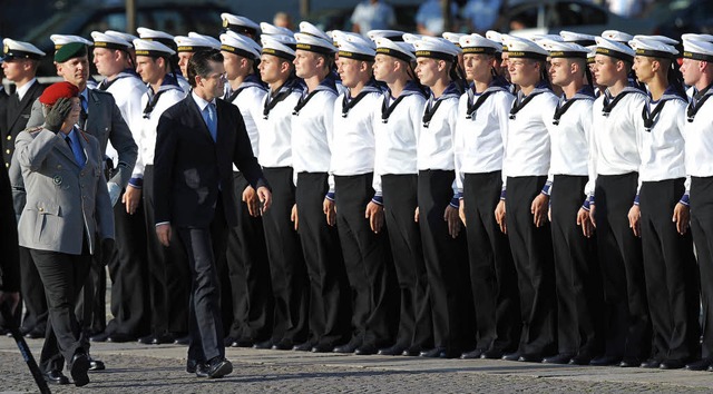 Verteidigungsminister  Guttenberg (rec...schreiten  die Reihen der Soldaten ab.  | Foto: DPA