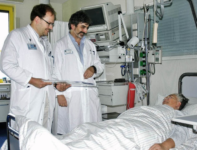 Oberarzt Jens Wattchow (links) und Che...dreas Hetzel  am Bett einer Patientin   | Foto: Wieschenkmper