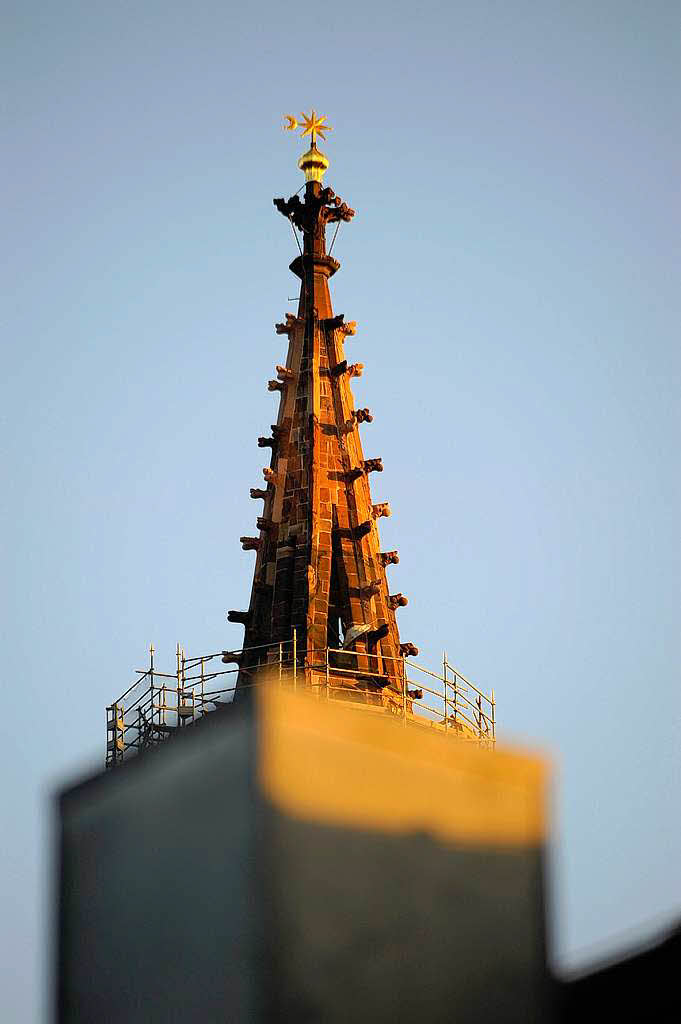 Spitze vom Mnsterturm ragt perspektivisch aus einem Schornstein