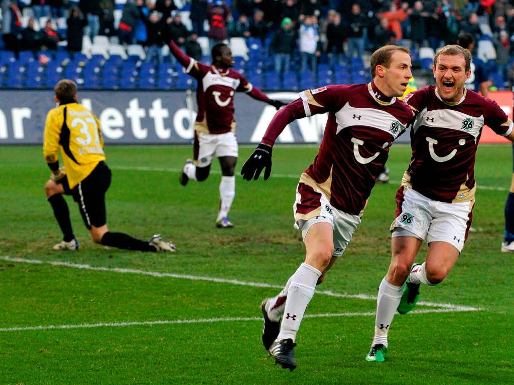 Hannovers Torschtze Jan Schlaudraff und Konstantin Rausch (r) jubeln nach dem Tor zum 1:0.