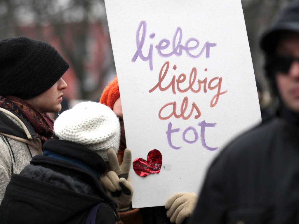 Demonstranten zeigen einem Schild mit der Aufschrift: "lieber liebig als tot".