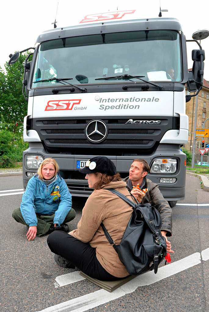 Drei Stuttgart-21-Gegner blockieren einen Laster vor dem Nordflgel des Hauptbahnhofs.