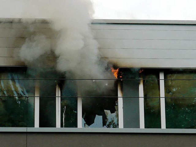 Rauch und Flammen schlagen aus den rc...ern im Obergeschoss zur Bahnlinie hin.  | Foto: Martin Wendel