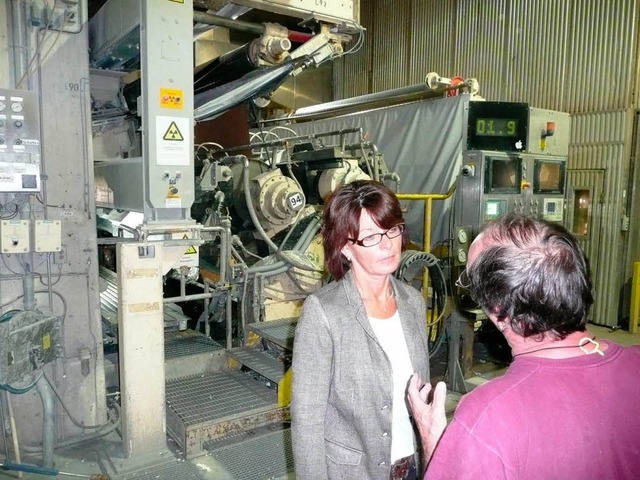 Marianne Kohls an einer Papiermaschine im Gesprch mit einem Kollegen.  | Foto: Peter Stellmach
