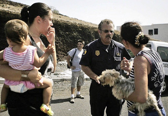 Bewohner von La Restinga informieren s...inem Polizisten ber die Evakuierung.   | Foto: DPA