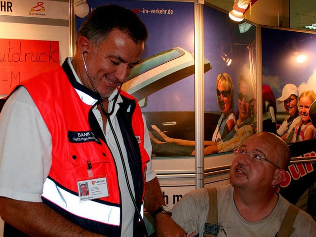 Trucker Georg Hoch lsst sich von eine...er der Malteser den Blutdruck messen.   | Foto: Saurer