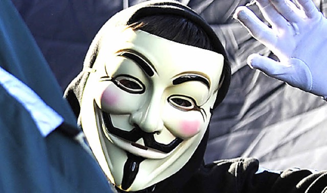 Die Aktivisten von Anonymous tragen di...ichen Masken wie die Occupy-Bewegung.   | Foto: dapd