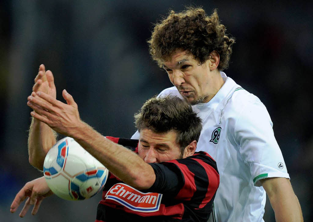 Freiburgs Stefan Reisinger (unten) und Hannovers Emanuel Pogatetz im Zweikampf um den Ball.