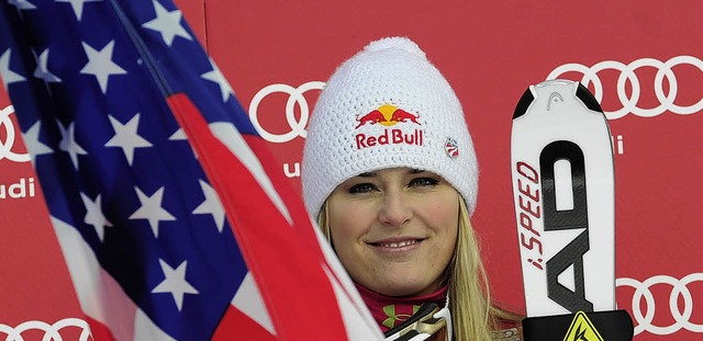 Eingerahmt von Nationalflagge und Skiern: Lindsey Vonn   | Foto: afp