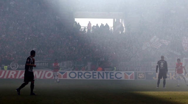 Dicker Nebel im Mainzer Stadion: Anhn...d des Derbys  Pyrofackeln angezndet.   | Foto: dpa