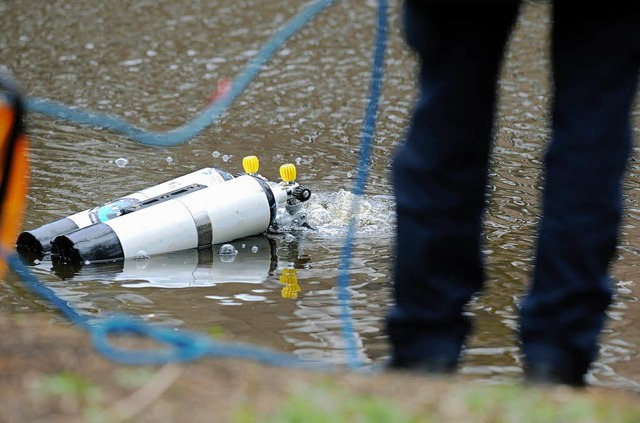 Polizeitaucher suchen nach der Tatwaffe.  | Foto: dpa