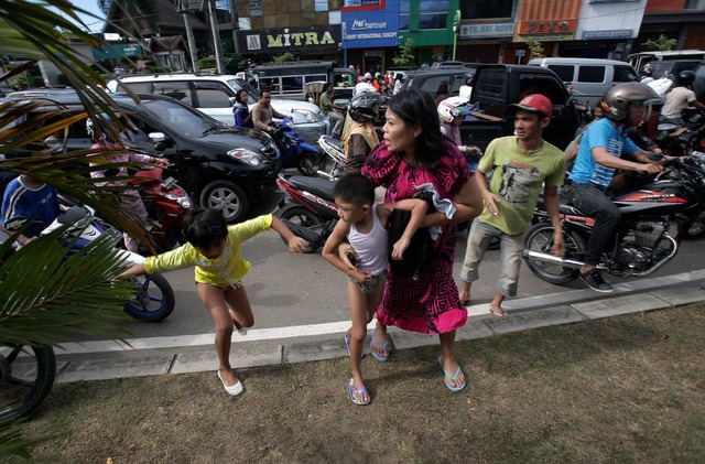 Menschen in der indonesischen Stadt Ba...te Sumatras ihre Stadt erreicht haben.  | Foto: AFP