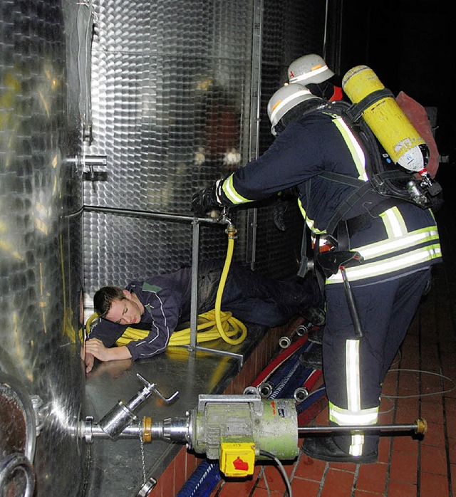 Feuerwehrleute entdecken einen &#8222;Verletzten&#8220; zwischen den Stahltanks.  | Foto: Roland Vitt