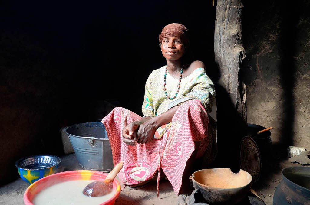 Deba Coulibaly, 46, Buerin aus Mali neben ihrer Feuerstelle beim Kochen von Hirsebrei: "Mein Vieh ist schon bei der letzten Drre gestorben. Und was ist ein Fulbe ohne Rinder? Jetzt, nach der schlechten Ernte, habe ich nur noch einen Sack Hirse fr meine Familie."