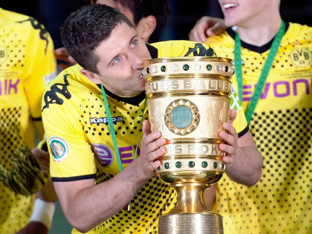 Dortmunds Robert Lewandowski ksst bei der Siegerehrung den DFB-Pokal.  | Foto: dapd