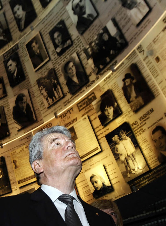Bundesprsident Joachim Gauck betracht...alem Bilder von Opfern des Holocaust.   | Foto: dpa