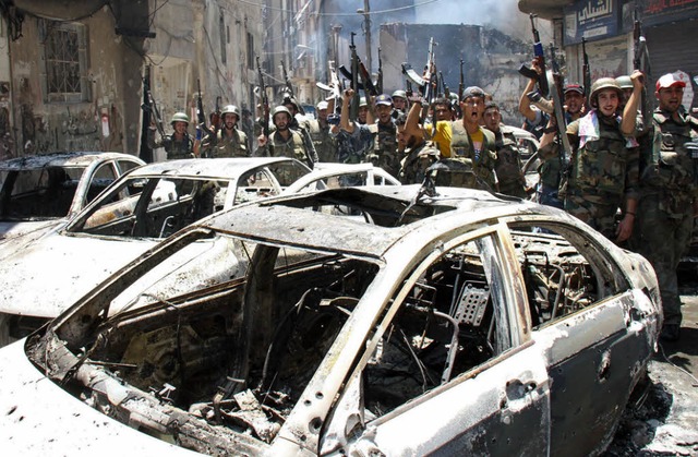 Rebellen feiern am Freitag die Eroberu...Viertels in der Hauptstadt Damaskus.    | Foto: DPA