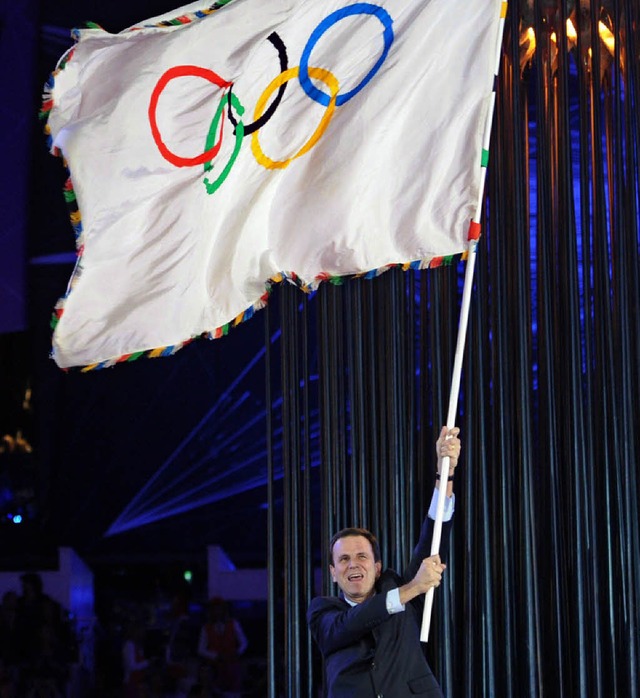 Rios Brgermeister Eduardo Paes schwenkt die Olympia-Flagge.  | Foto: AFP