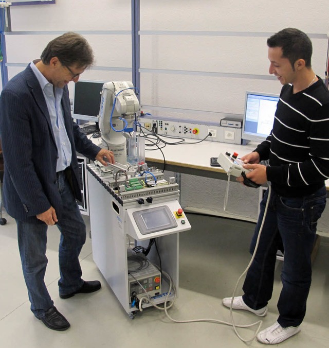 Denis Izetoski (rechts) an einem Robot... vom PC aus programmiert werden kann.   | Foto: ZvG