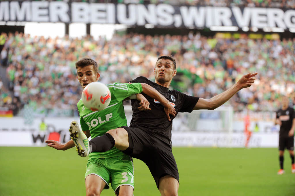 Caligiuri kmpft mit Wolfsburgs Hasani um den Ball.