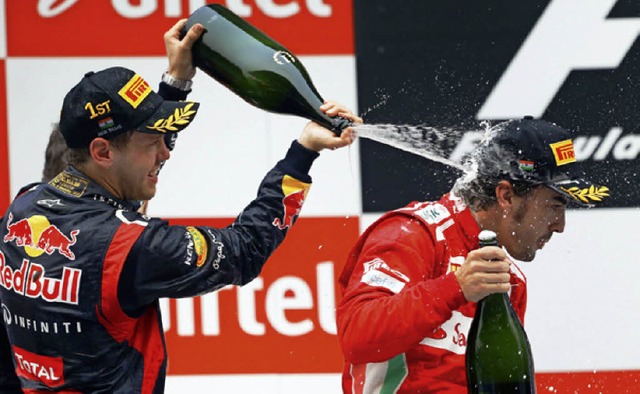 Auch das noch: Sebastian Vettel duscht Fernando Alonso auf dem Podium.  | Foto: dpa