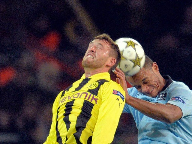 Mit Kpfchen: Dortmunds Julian Schiebe...ersucht  Vincent Kompany zu berlisten  | Foto: dpa
