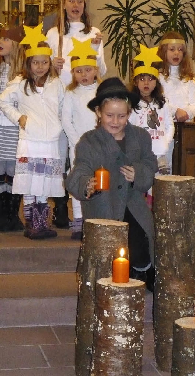 Ein kleiner Hirte bringt die Kerze fr...terne ihn mit ihrem Gesang begleiten.   | Foto: Marianne Rittner