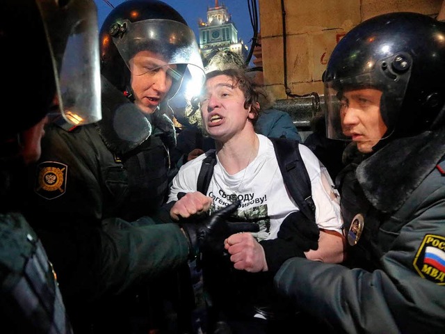 Ein Polizist nimmt in Moskau einen Demonstranten fest.   | Foto: DPA
