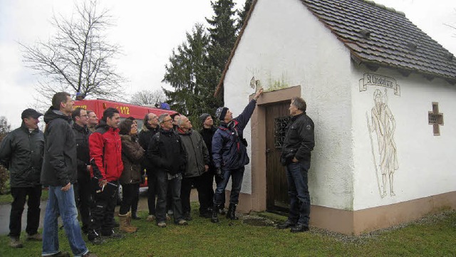 Bei der Ortsbegehung des Gemeinderats ...  erlutert die ntigen Malerarbeiten.  | Foto: Pia Grttinger