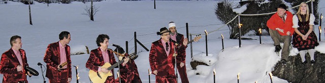 Moderator Michael Kost,  rechts auf de...band Luddi bei Fackelschein im Schnee.  | Foto: Wilfried Dieckmann