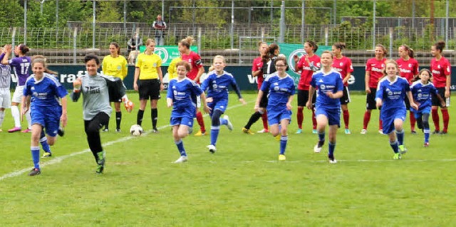 Die E- und D-Juniorinnen vom SV Schopf...ns Mslestadion in Freiburg einlaufen.  | Foto: Monika Weber