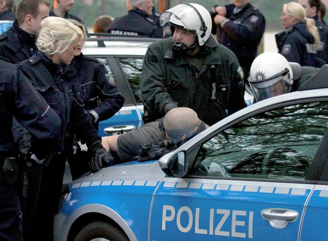 Die Polizei nimmt bei Ausschreitungen ...dion des MSV Duisburg einen Mann fest.  | Foto: dpa