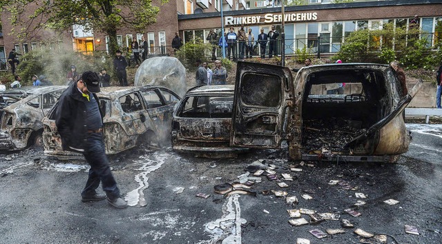 Ausgebrannte Autos auf dem Marktplatz des Stockholmer Vororts Rinkeby   | Foto: AFP