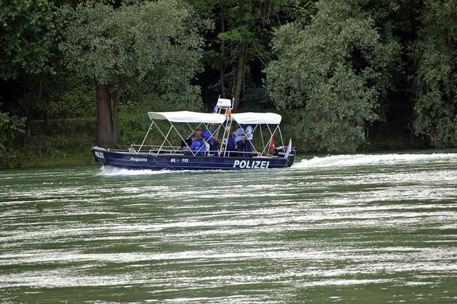 Ein Polizeiauto plumpst in den Rhein