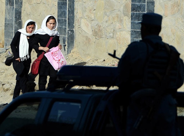 Zwei afghanische Schlerinnen passiere...dent Hamid Karsais Regierungspalast.    | Foto: afp