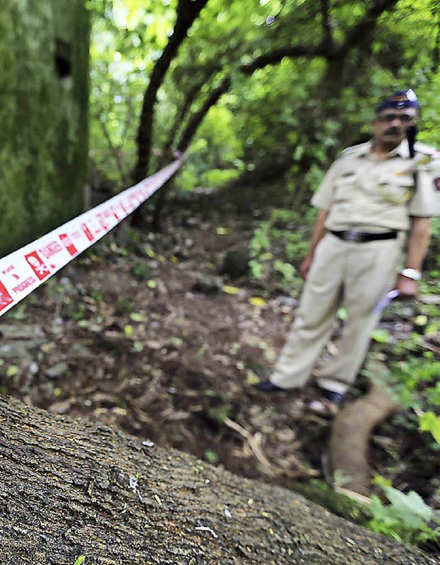 Ein  Polizist inspiziert den Tatort in Mumbai.   | Foto: dpa