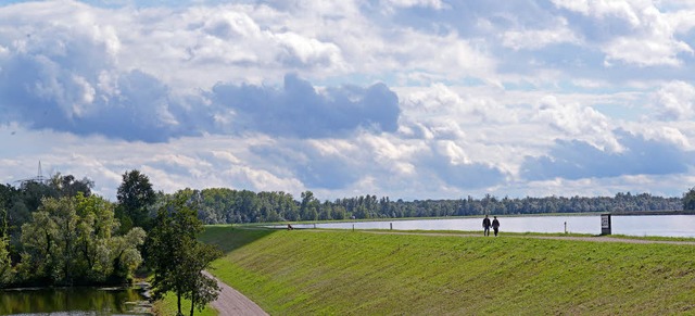 Ein Paar flaniert ber den Rheindamm b...von ihnen ein Rckhalteraum entstehen.  | Foto: dpa