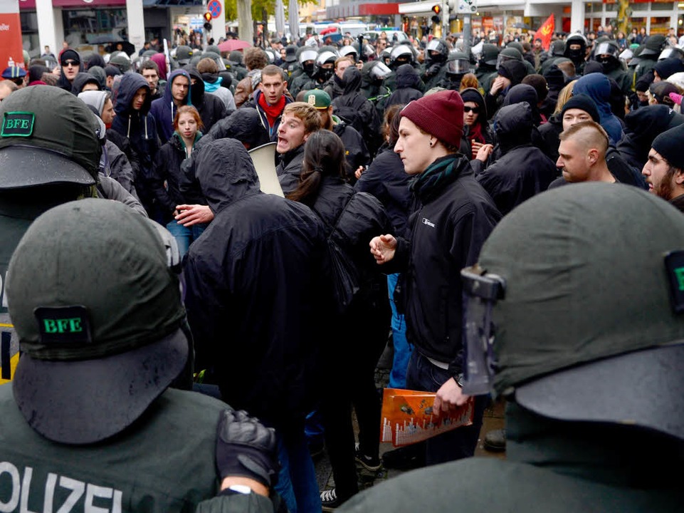 Polizeikräfte kesseln linke Gegendemonstranten ein.  | Foto: dpa
