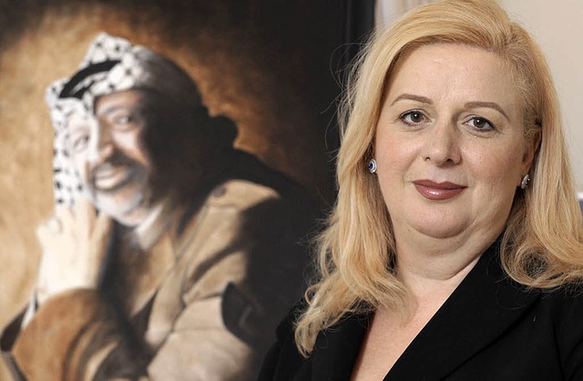 Suha Arafat vor dem Bildnis ihres verstorbenen Mannes   | Foto: AFP