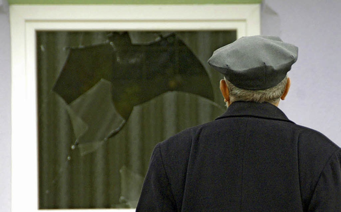 Unglubig blickt ein  Muslim im Novemb...e eingeworfenen Scheiben der Moschee.   | Foto: Ralf Staub
