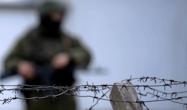 Vermutlich ein Russe bewacht eine Kase...chen Militrs auf der Halbinsel Krim.   | Foto: AFP