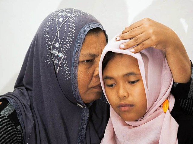 Zehn Jahre lang glaubte Jamaliah Janna... auch der nach wie vor vermisste Sohn.  | Foto: AFP