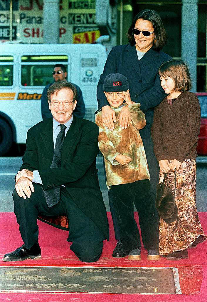 1998: Robin Williams  posiert mit seinen Tchtern Cody (Mitte), Zelda (rechts) und seiner damalige Frau Marsha whrend seiner Hand-und Fuabdruck-Zeremonie vor dem  TCL Chinese Theatre in Hollywood.